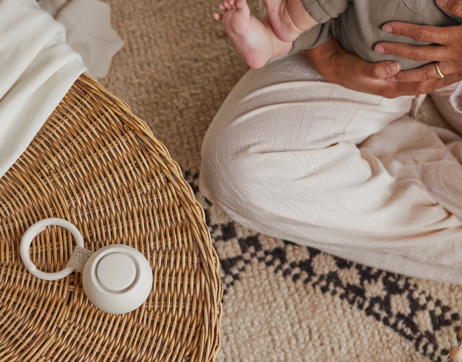 Hatch Go Putty on a table next a mother cradling her baby