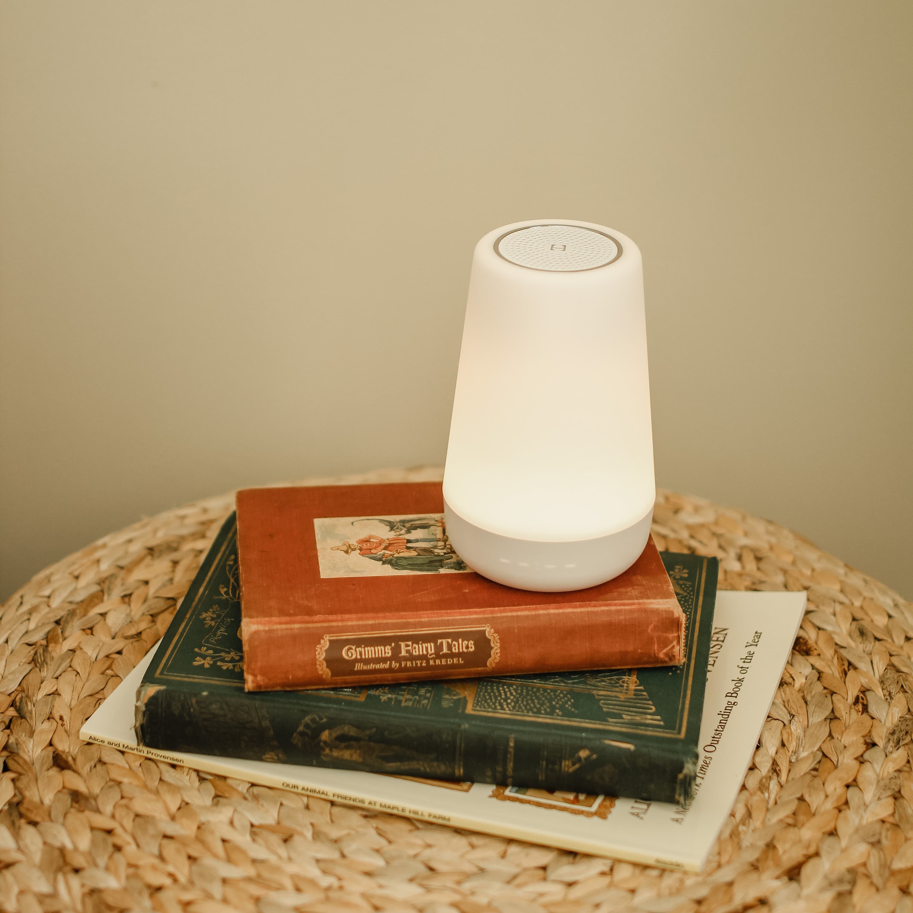Hatch Rest sitting on an end table on top of some fairy tale books