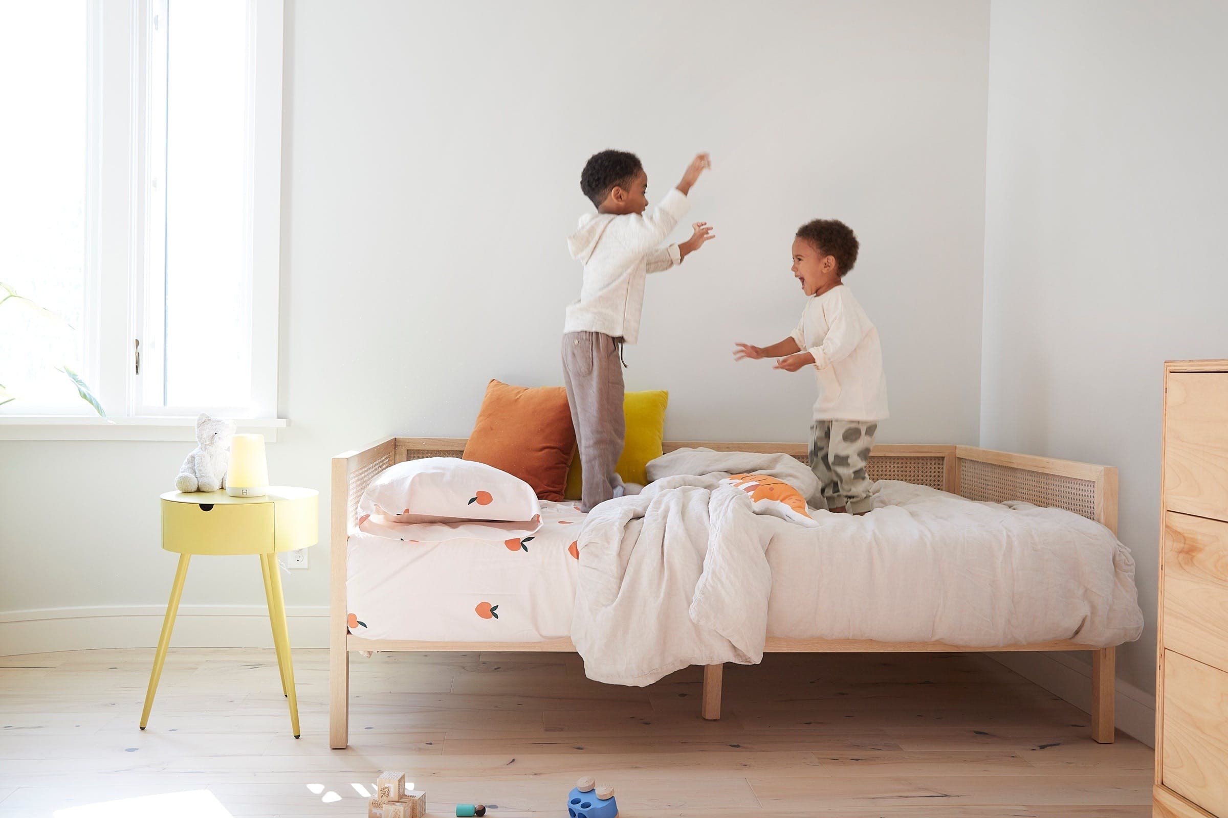 Two kids play in their bedroom with Hatch Rest illuminated