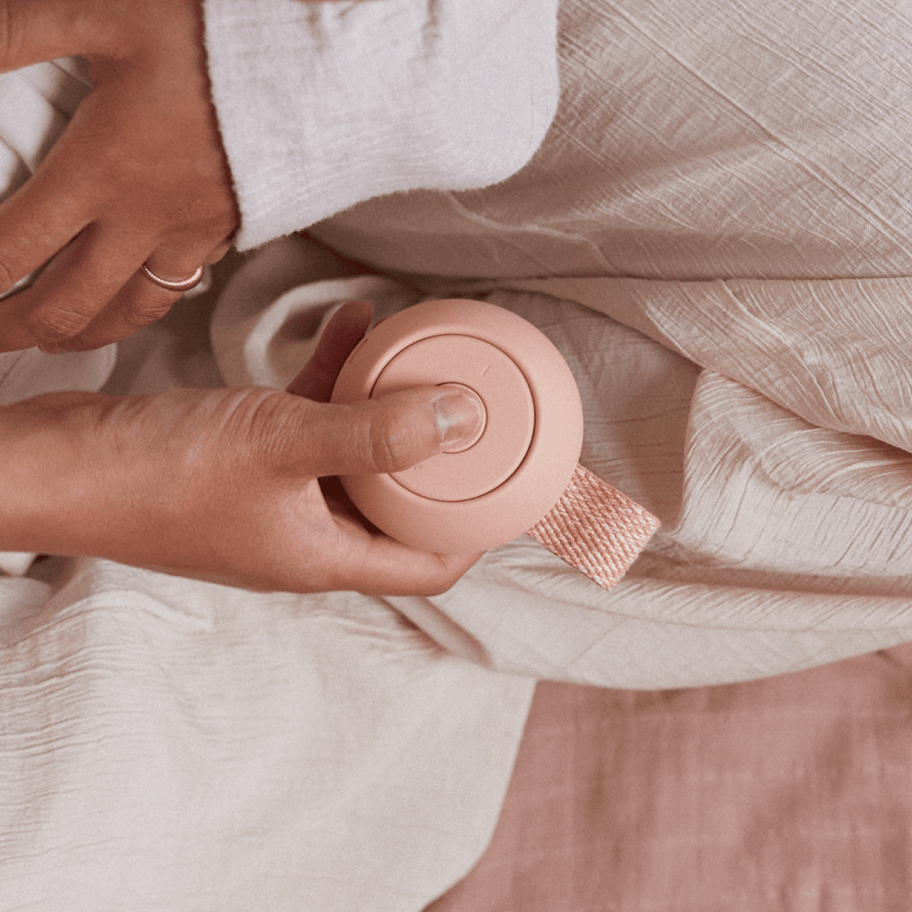 Woman pressing button on Hatch rest go in peach