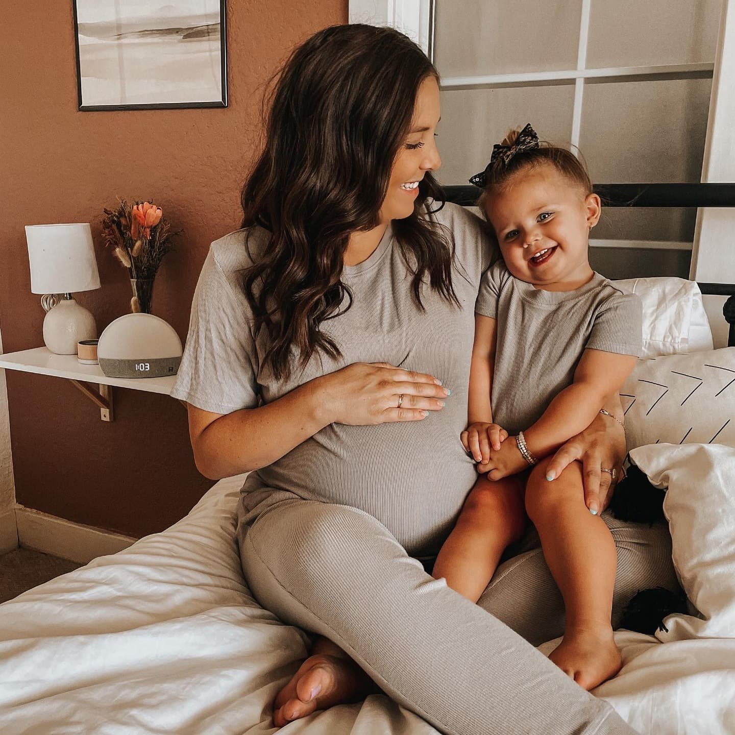 Pregnant mother holding her daughter