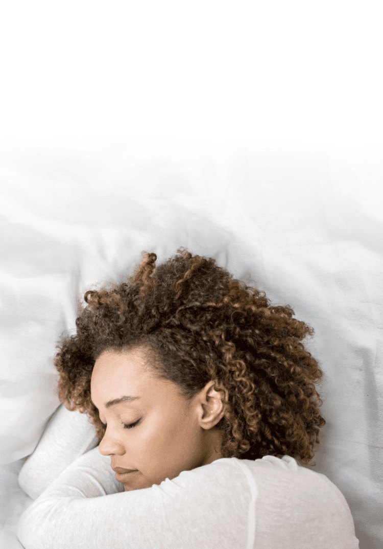 A woman sleeping on a bed