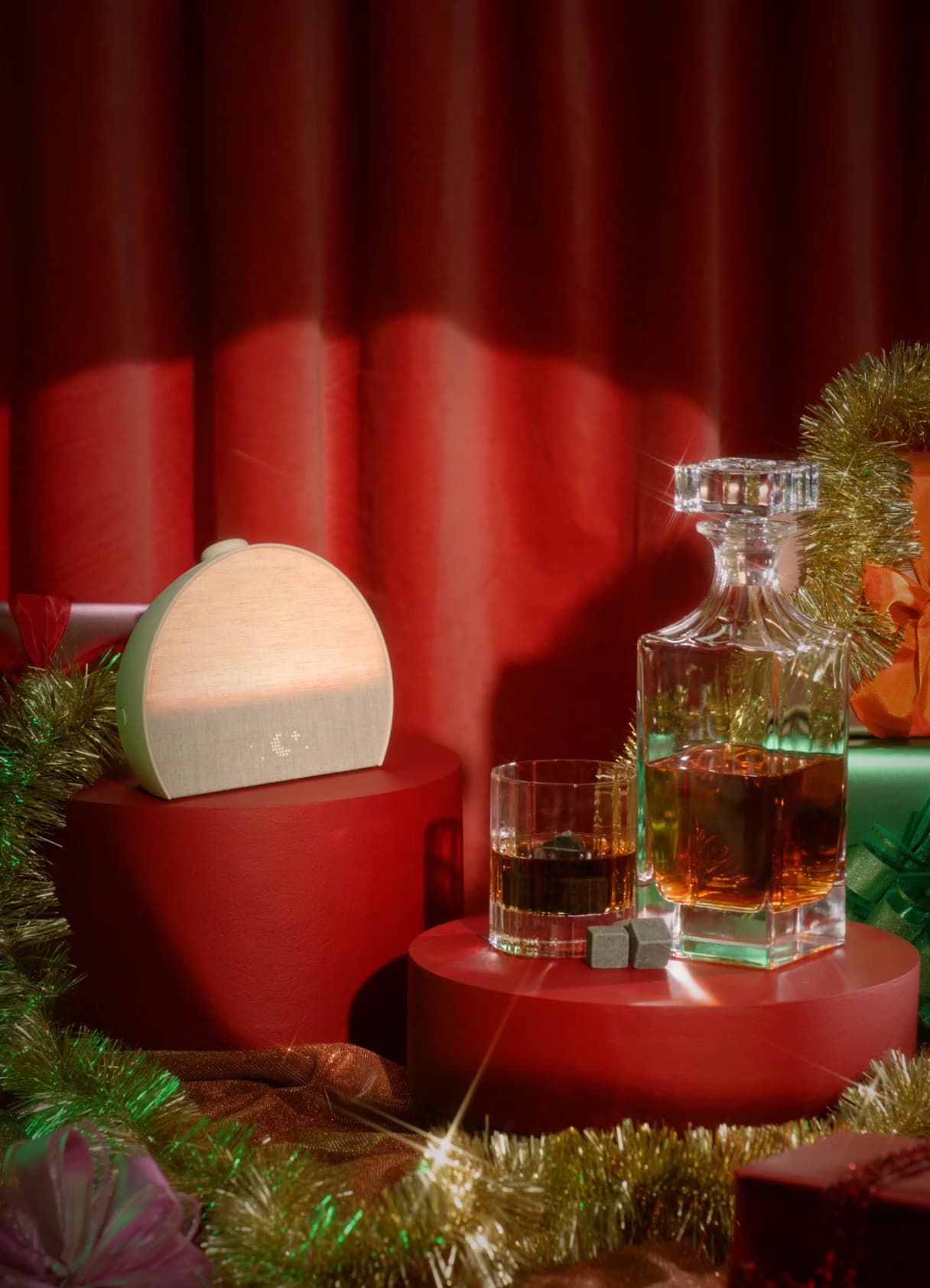 Hatch Restore 3 on a holiday pedestal next to gifts and a whiskey decanter