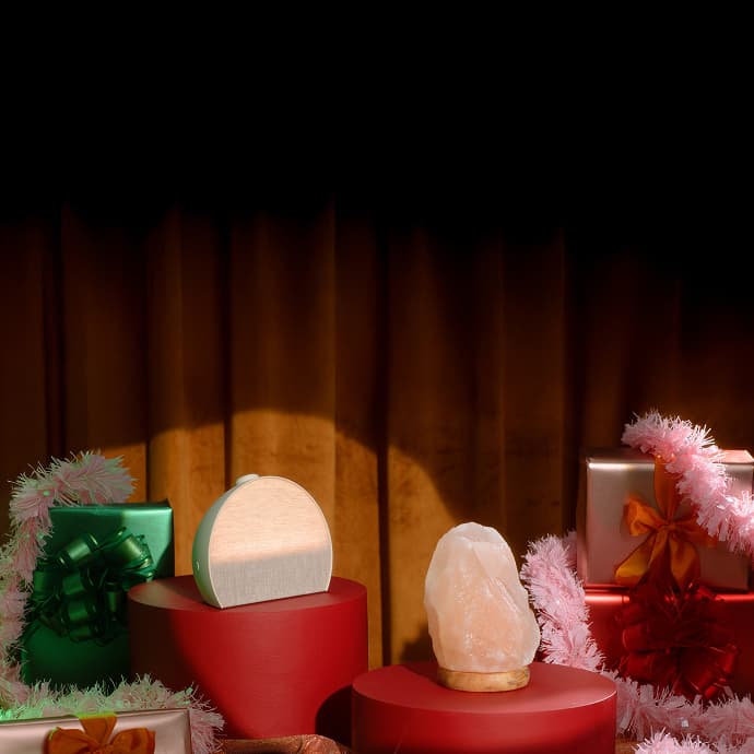 Hatch Restore 3 on a holiday pedestal next to gifts and a crystal