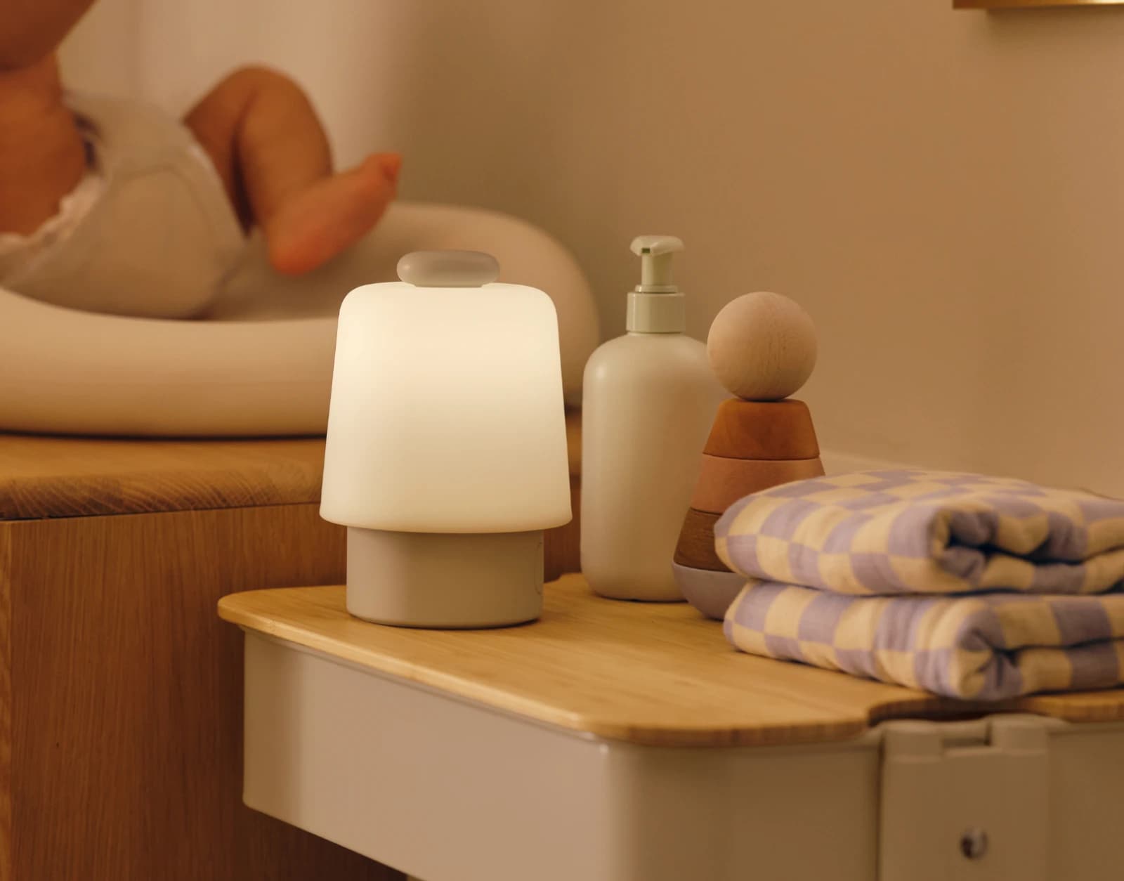 Hatch Baby Greige sitting on a nursery changing table