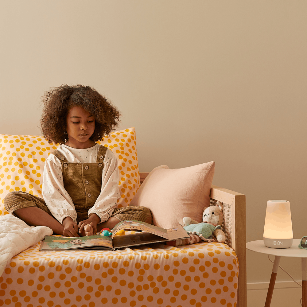 Rest+ lamp on while a child reads a book