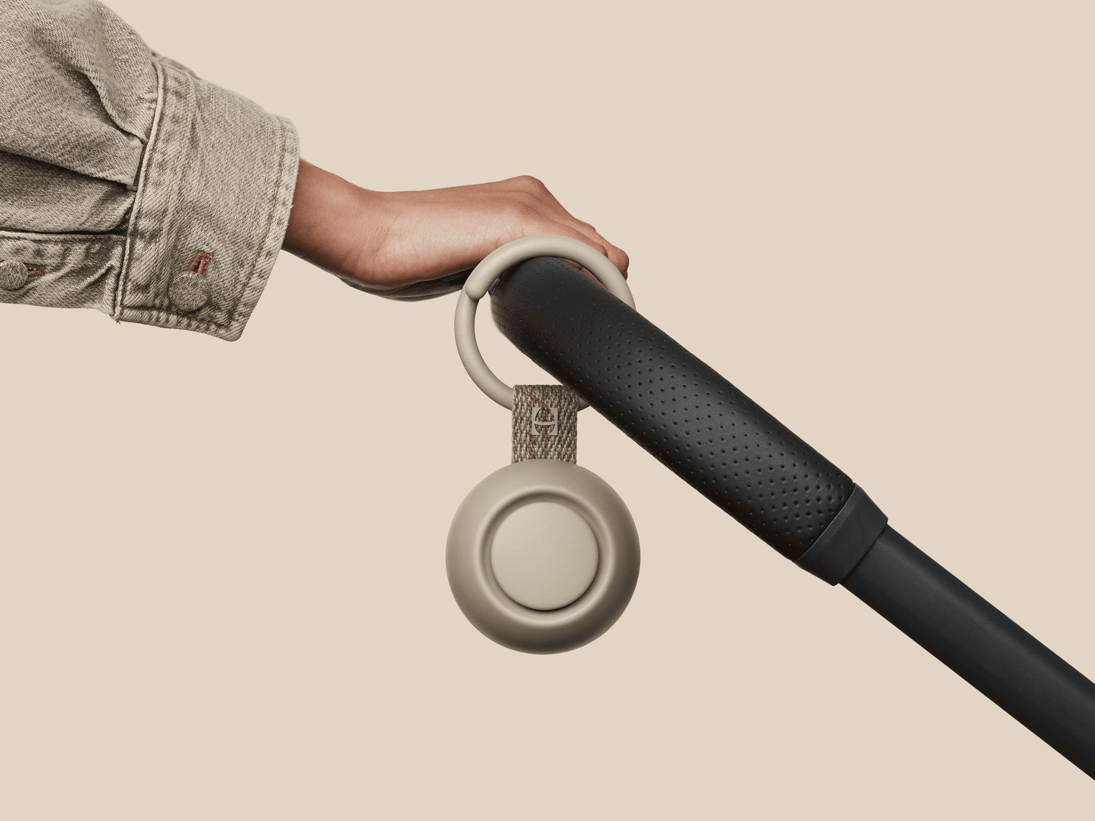 Hatch Go greige colorway clipped to baby stroller