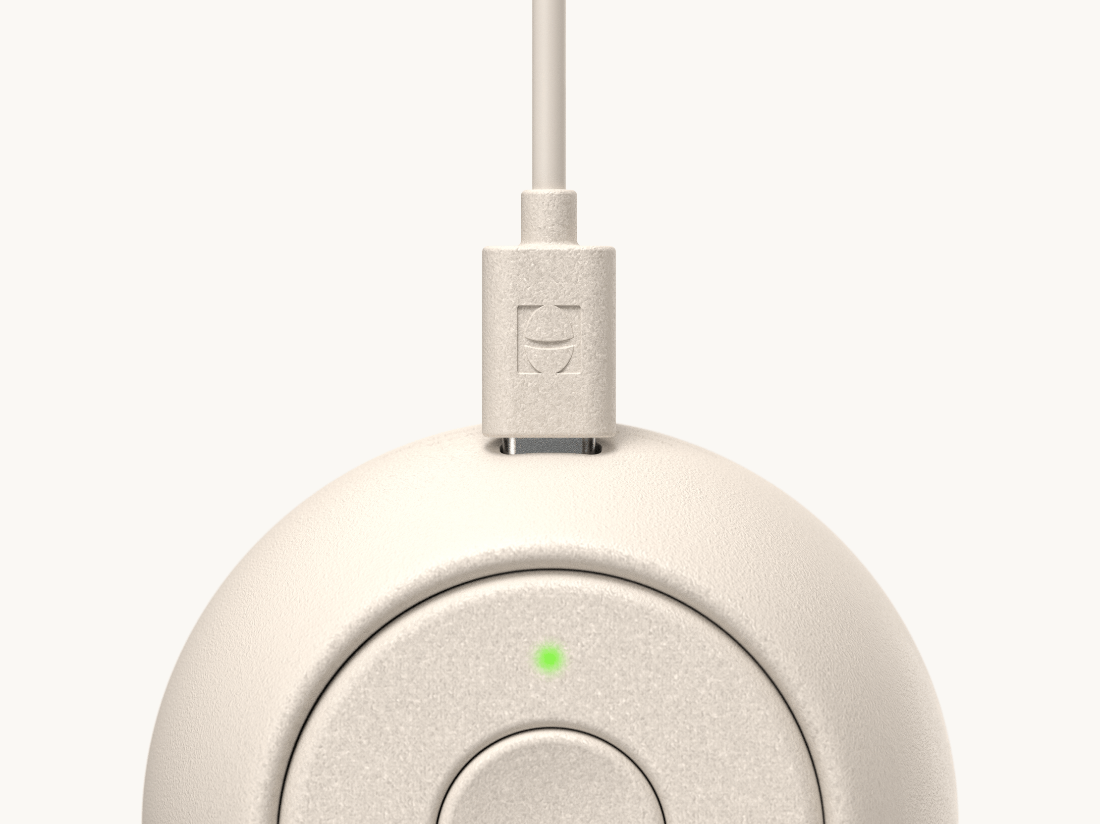 Hatch Go putty colorway with included charger plugged in